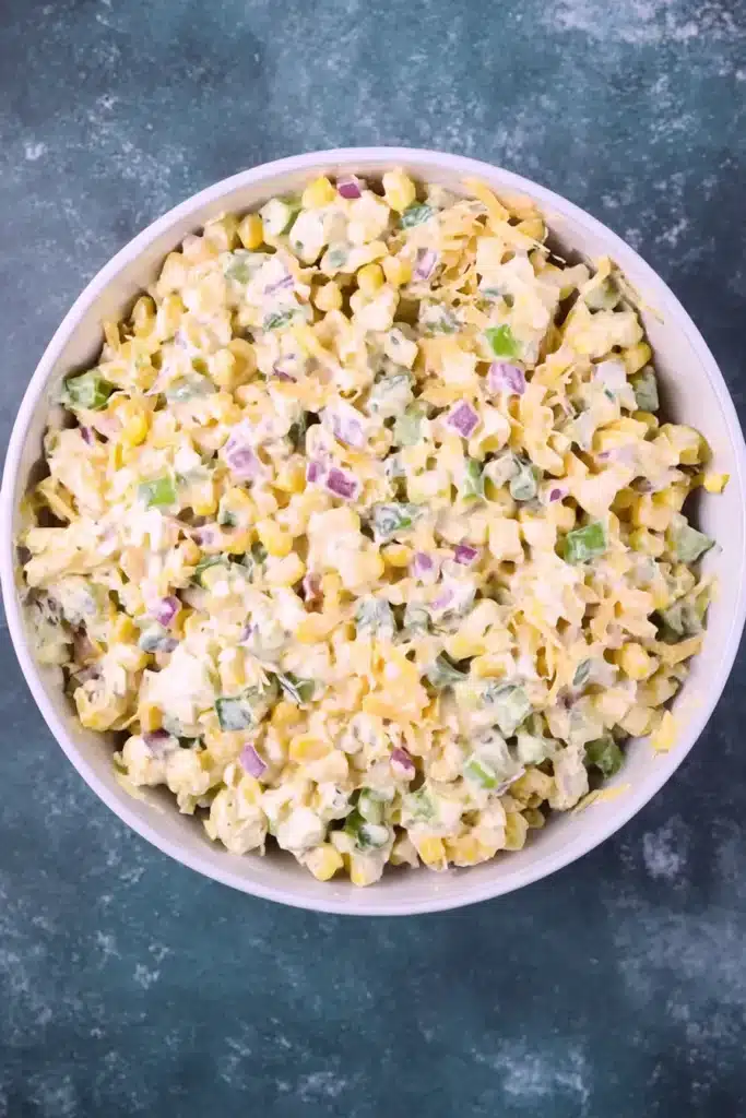 Mixed Frito Corn Salad base with corn, cheese, peppers, onions, and creamy dressing