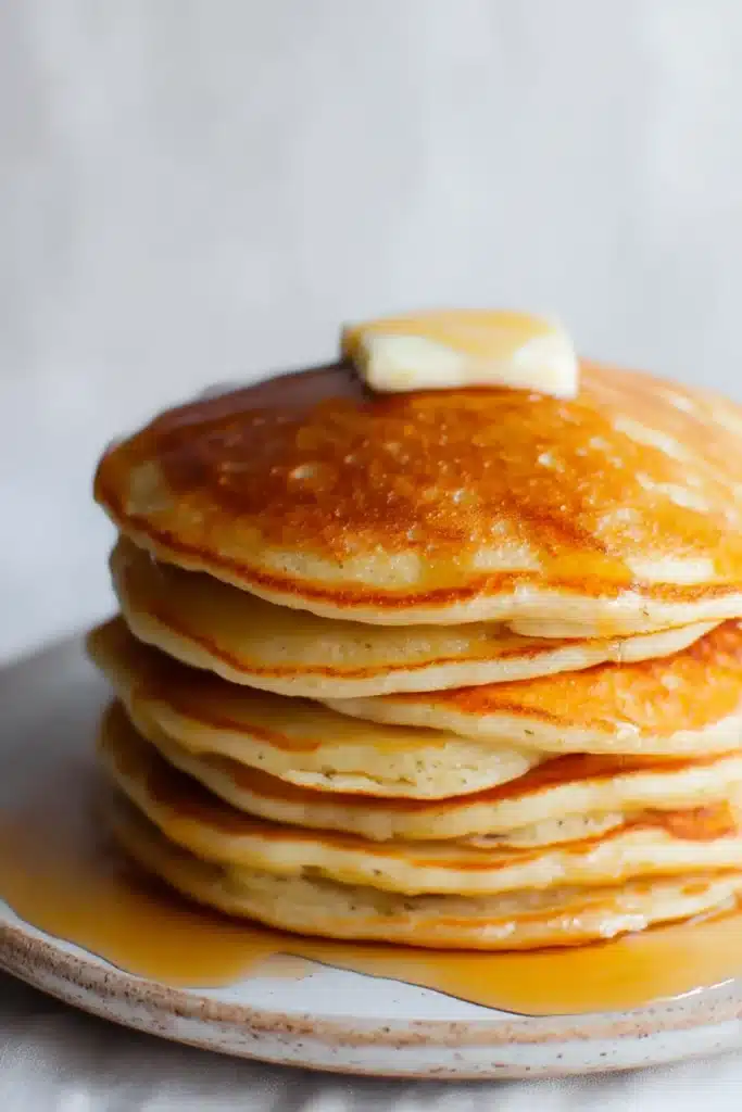 Easy oatmeal apple pancakes with melting butter and maple syrup