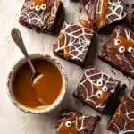 Halloween Spiderweb Brownies – A Spooky and Delicious Treat 7 Fudgy Halloween spiderweb brownies with caramel filling and marshmallow webs