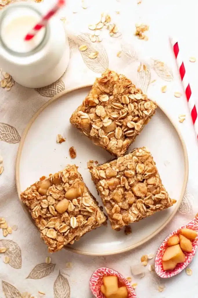 Overhead view of healthy small batch apple crumble bars with oat topping on white plate