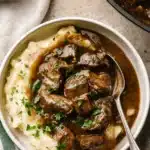 Instant Pot Beef Tips – Tender & Easy Dinner Recipe 11 Bowl of Instant Pot beef tips with gravy over mashed potatoes, garnished with parsley