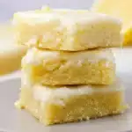 Lemon Brownies Recipe – Sweet, Tangy & Irresistible Treat 6 Moist lemon brownies stacked on a plate with glaze topping