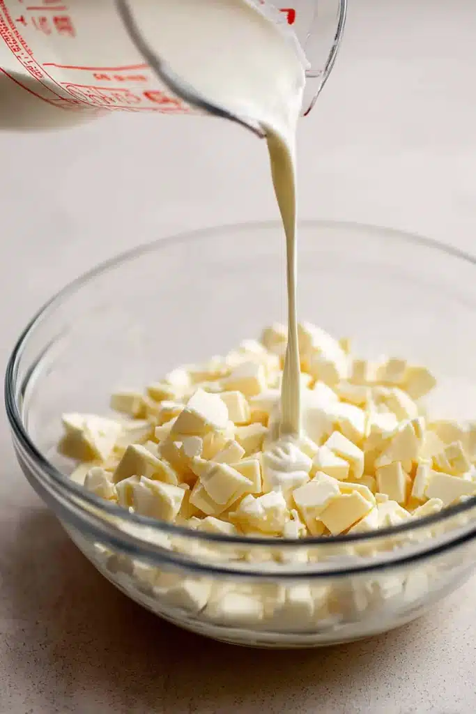 Lemon Truffles Recipe | Easy White Chocolate Treat 12 Pouring hot cream into white chocolate for lemon truffles ganache