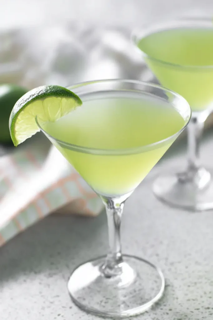 Simple Green Apple Soda with Homemade Juice served in a martini glass with lime garnish