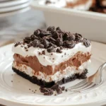 No-Bake Chocolate Oreo Lasagna | Easy & Irresistible Treat 5 Slice of no-bake chocolate Oreo lasagna with whipped topping and mini chocolate chips