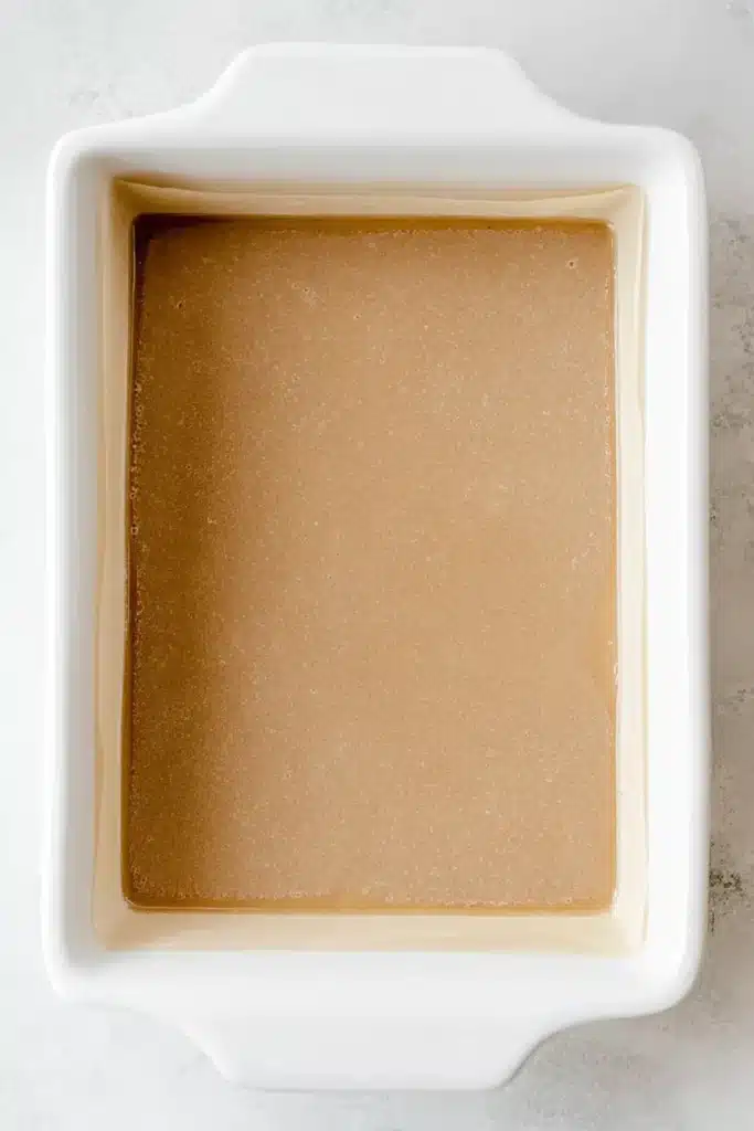 Prepared baking dish lined with parchment for Easy Cinnamon Apple Cake