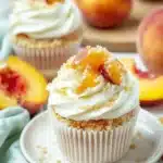 Peach Cobbler Cupcakes – A Stunning Summer Dessert 8 Peach cobbler cupcakes topped with cream cheese frosting and peach streusel