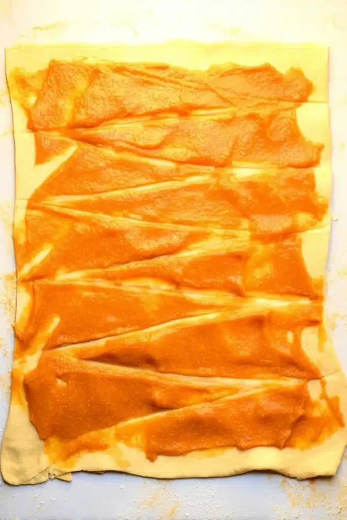 Pumpkin pie filling spread over crescent roll dough for mini crescent rolls