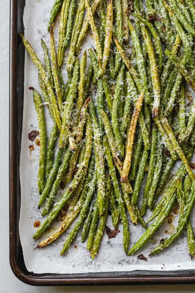 Roasted Green Beans With Garlic and Parmesan | Easy Recipe 14 Roasted Green Beans With Garlic and Parmesan on a parchment-lined baking sheet