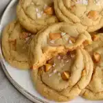 Salted Butterscotch Cookies – Easy, Soft, and Delicious 8 Soft salted butterscotch cookies with flaky sea salt on a white plate