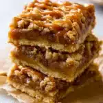 Salted Caramel Apple Bars – Cozy & Delicious Fall Favorite 11 Stacked salted caramel apple bars with oat streusel and rich caramel drizzle