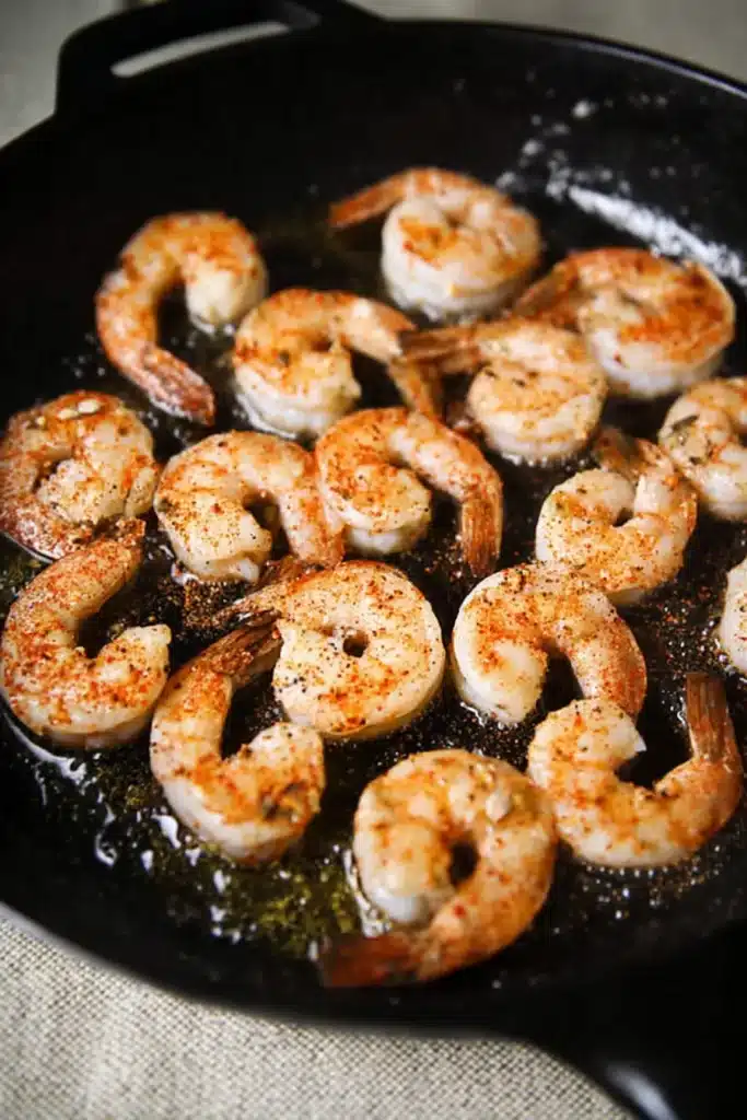 Shrimp cooking in skillet for shrimp and creamed corn recipe