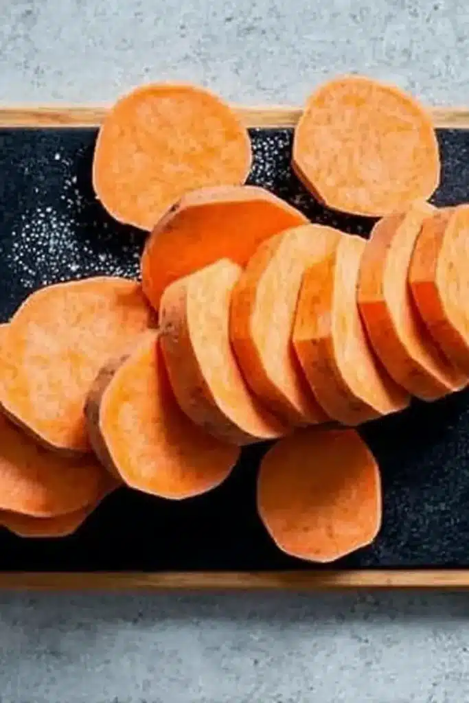 Roasted Sweet Potatoes – Easy, Crispy & Delicious 9 Sliced sweet potatoes for roasting on cutting board