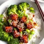 Baked Teriyaki Salmon Recipe in white bowl with rice, broccoli, and edamame on gray kitchen table