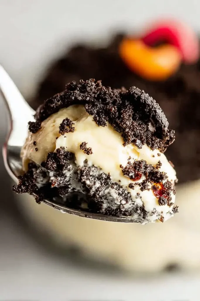 The Best Oreo Dirt Cake – Fun, Creamy, Crowd-Pleaser 13 Spoonful of The Best Oreo Dirt Cake with pudding and crushed Oreos