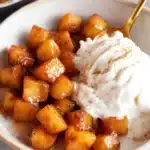 Air Fryer Apples – Quick & Amazing Cinnamon Maple Recipe 11 Warm cinnamon maple glazed air fryer apples with vanilla ice cream in a ceramic bowl