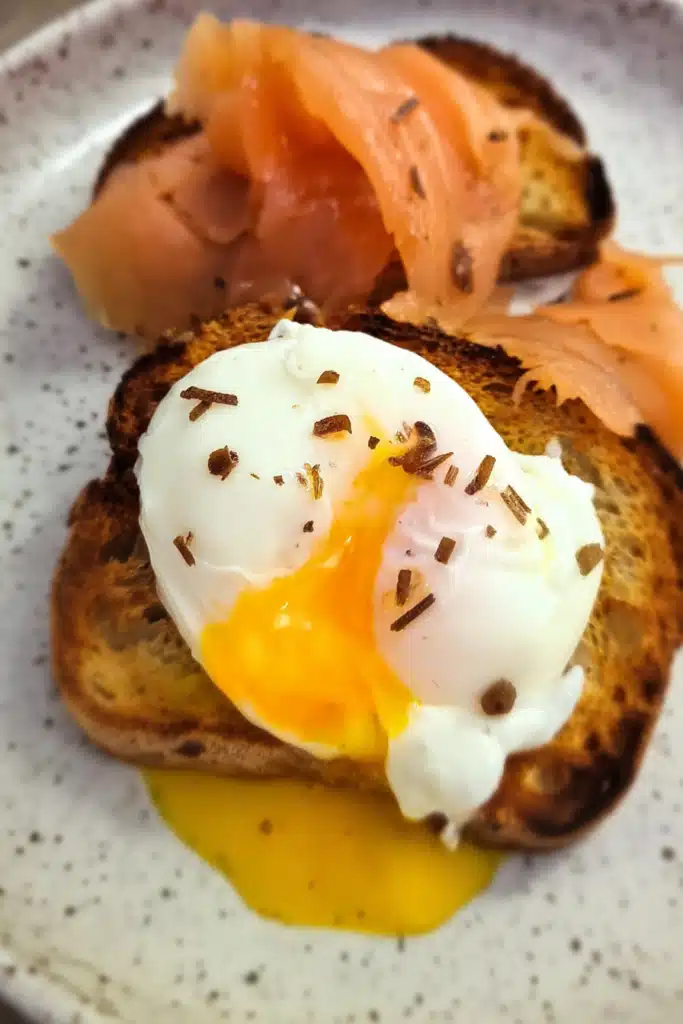 Air Fryer Poached Eggs served on crispy toast with runny yolk and smoked salmon