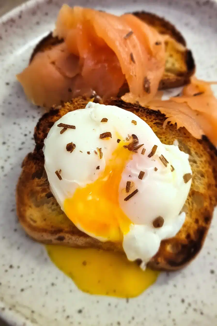 Air Fryer Poached Eggs served on crispy toast with runny yolk and smoked salmon