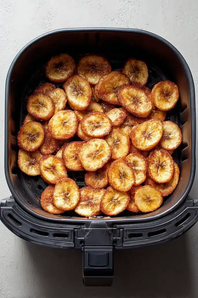 Easy Cinnamon Air Fryer Banana Chips – Quick & Amazing 8 Sweet Cinnamon Air Fryer Banana Chips in black air fryer basket