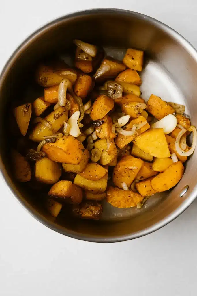 Roasted vegetables in pot for Spicy Butternut Squash and Sweet Potato Soup