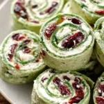 Cranberry and feta pinwheels with spinach tortillas on a serving plate