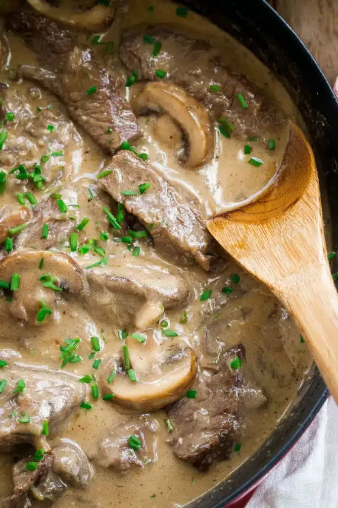 Close-up of creamy beef stroganoff with mushrooms and chives