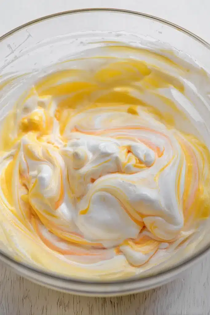 Orange Creamsicle Cake Recipe – Simple & Refreshing Treat 26 Swirled orange creamsicle cake topping with whipped cream and sherbet