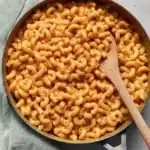 Creamy Pumpkin Pasta | Quick & Delicious Comfort 12 Creamy pumpkin pasta in skillet with wooden spoon