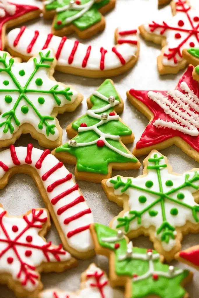 Colorful decorated Christmas cookies on white table