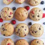 Favorite Yogurt Muffins – Easy, Moist & Absolutely Delicious 12 Favorite yogurt muffins with fruit and chocolate on a wooden surface