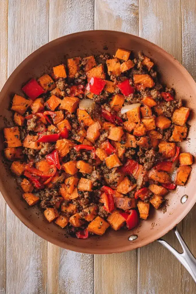 Finished sweet potato breakfast hash in copper skillet