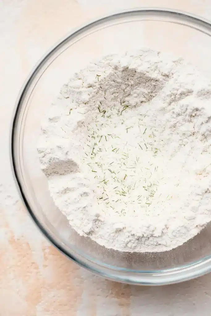 Easy garlic bread rolls flour mix with herbs in glass bowl
