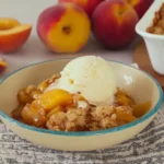 Fresh Southern Peach Cobbler | Amazing & Easy Dessert 6 Warm bowl of fresh Southern peach cobbler with vanilla ice cream and ripe peaches