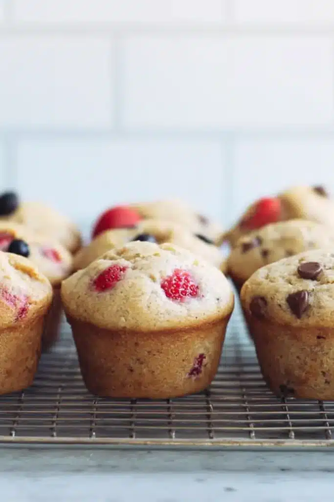 Favorite Yogurt Muffins – Easy, Moist & Absolutely Delicious 8 Favorite yogurt muffins cooling on rack with chocolate and berries