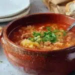 Golumpki Soup – Simple, Hearty, and Amazing Comfort 8 Hearty Golumpki Soup with cabbage, rice, and sausage in a rustic ceramic bowl