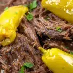 Close-up of Instant Pot Mississippi Pot Roast with pepperoncini peppers and rich gravy