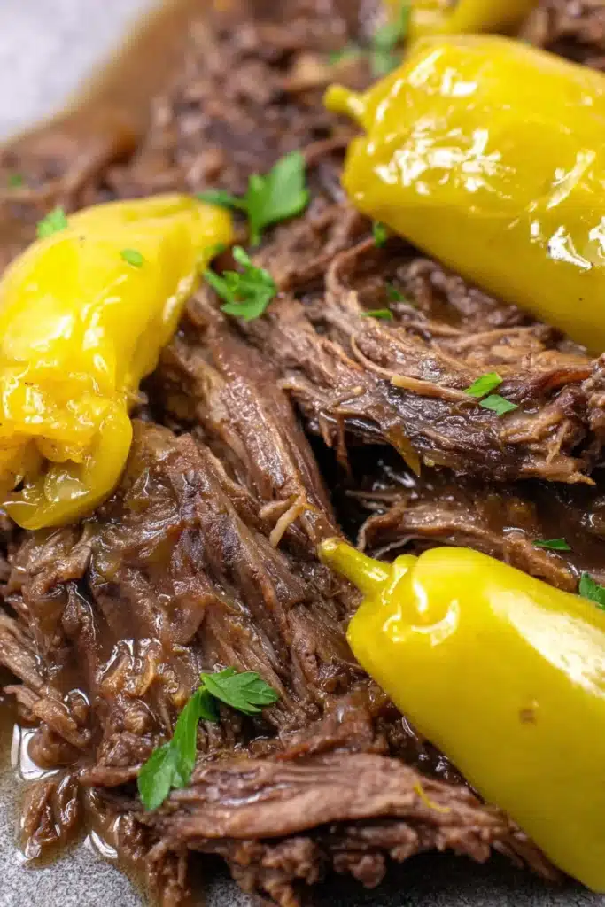 Close-up of Instant Pot Mississippi Pot Roast with pepperoncini peppers and rich gravy