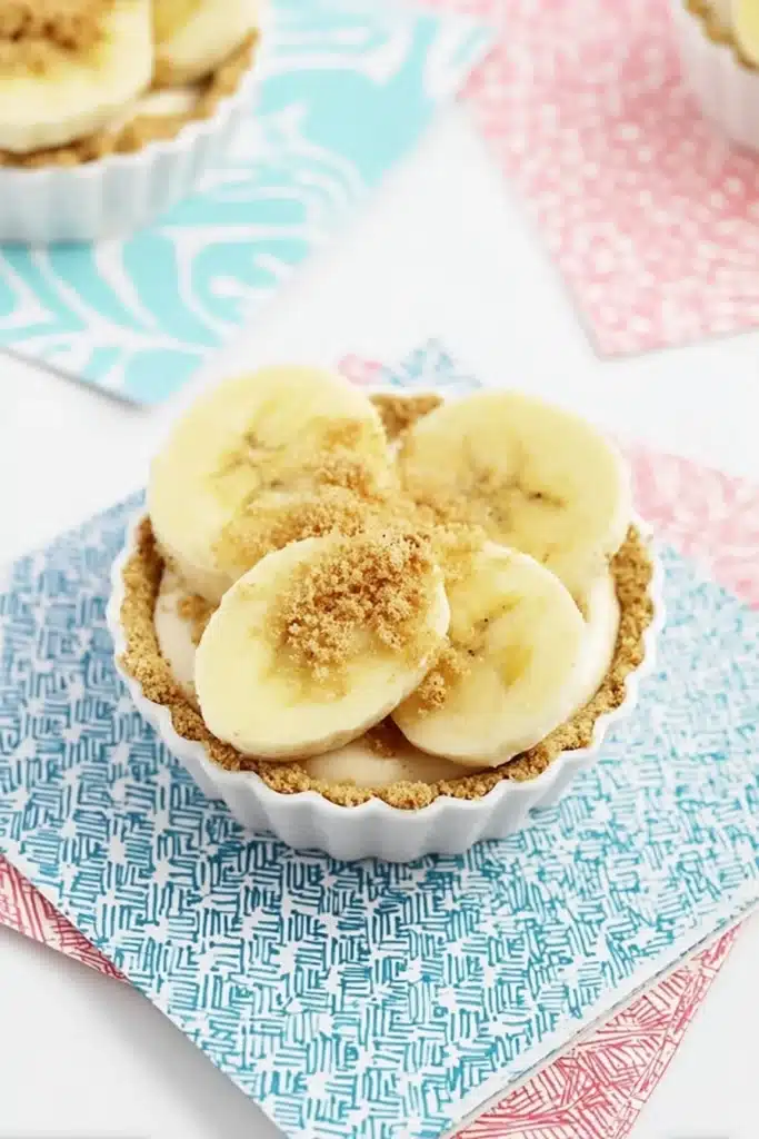Mini Banana Cream Pies topped with fresh banana slices and graham crumbs