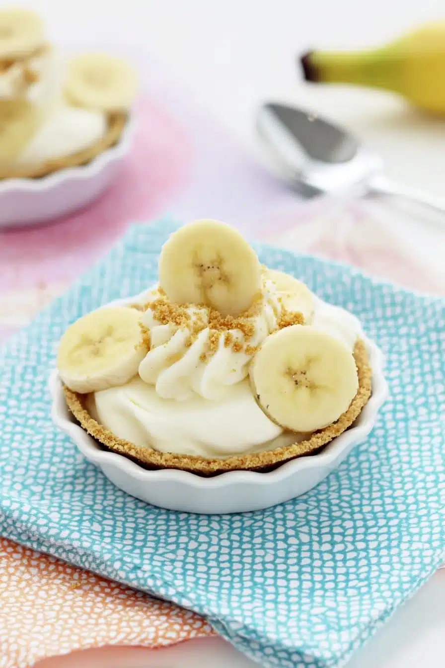 Mini Banana Cream Pies topped with whipped cream and banana slices