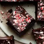 Fudgy one bowl peppermint brownies with glossy ganache and crushed candy topping