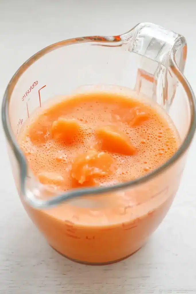 Orange Creamsicle Cake Recipe – Simple & Refreshing Treat 24 Orange creamsicle cake filling mixture with sherbet in glass cup
