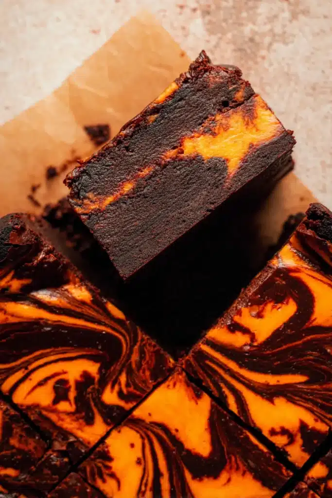 Top view of Halloween brownies with vibrant orange cheesecake swirl