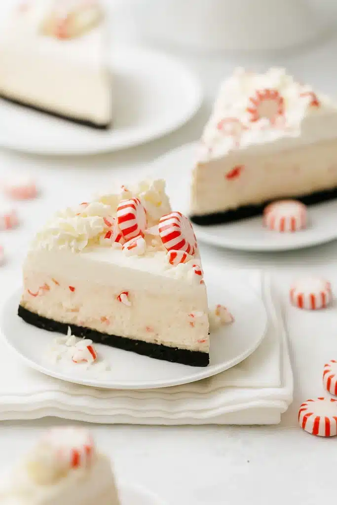 Slice of white chocolate peppermint cheesecake on white plate