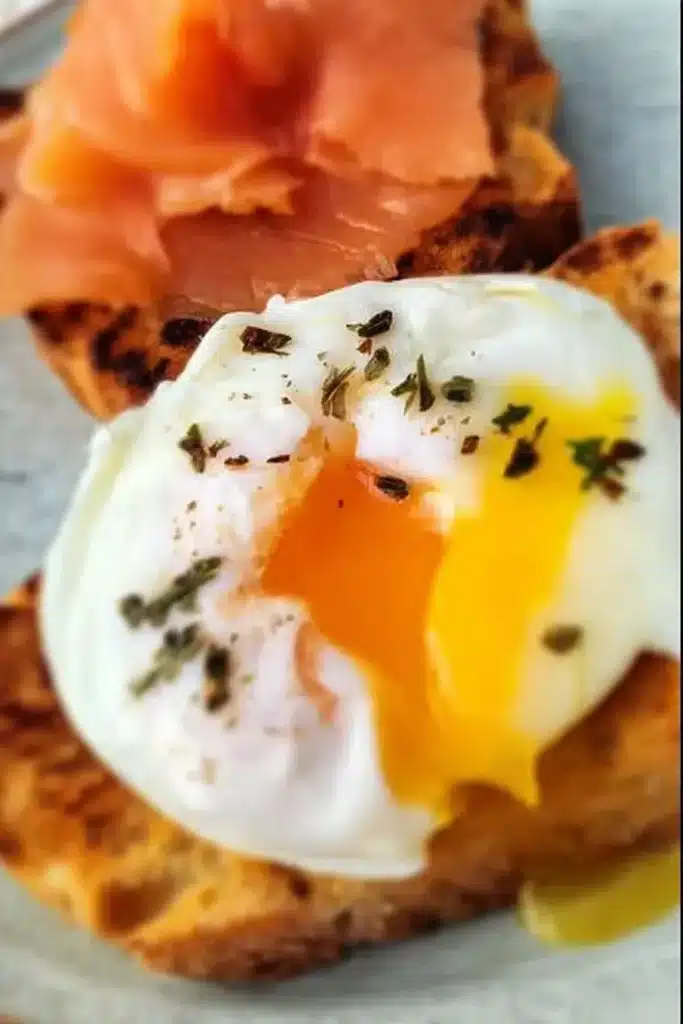 Air Fryer Poached Egg with runny yolk on toast and smoked salmon