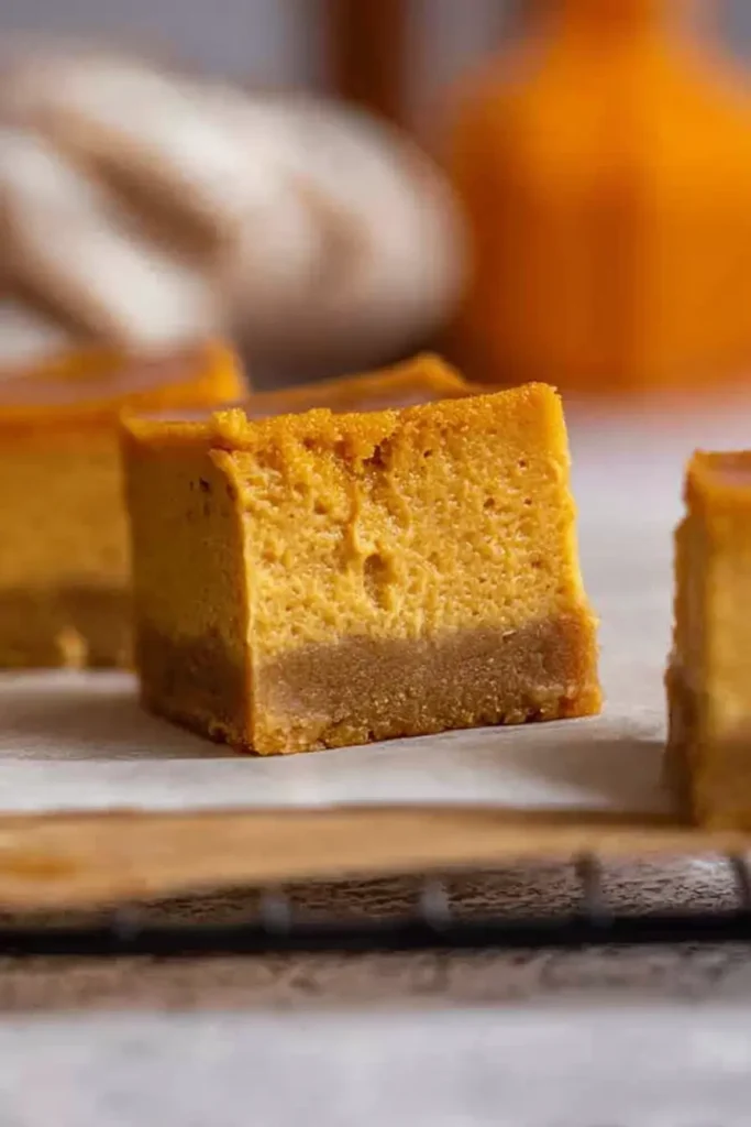 The Best Pumpkin Cheesecake Bars Ever cooling on rack with crust detail