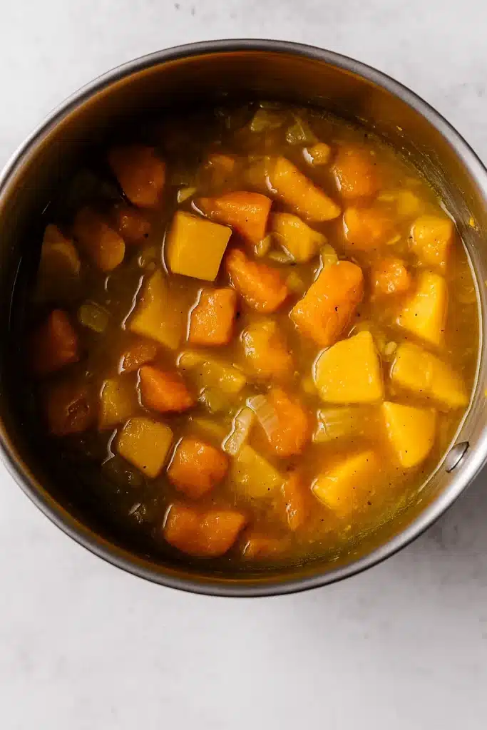 Simmering vegetables and broth for Spicy Butternut Squash and Sweet Potato Soup