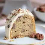 Keto Butter Pecan Pound Cake – Moist, Nutty & Delicious 12 Single slice of keto butter pecan pound cake on a white plate