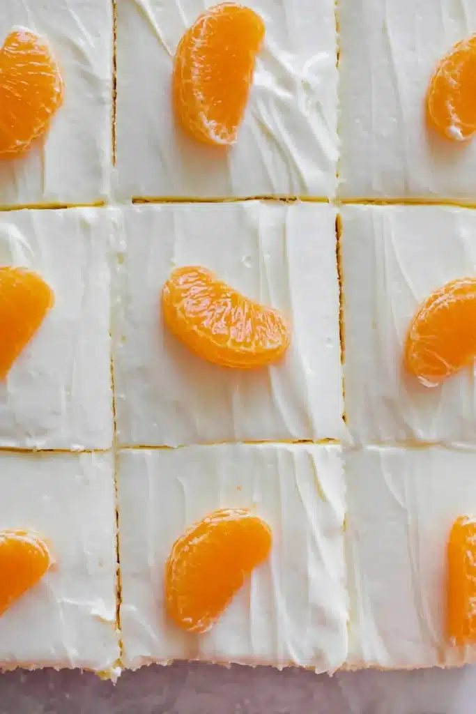 Orange Creamsicle Cake Recipe – Simple & Refreshing Treat 29 Orange creamsicle cake slices topped with mandarin orange segments