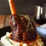Slow Cooked Lamb Shanks in Red Wine Sauce served on mashed potatoes