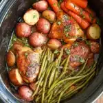 Slow Cooker Honey Garlic Chicken and Veggies in crockpot with carrots, potatoes, and green beans